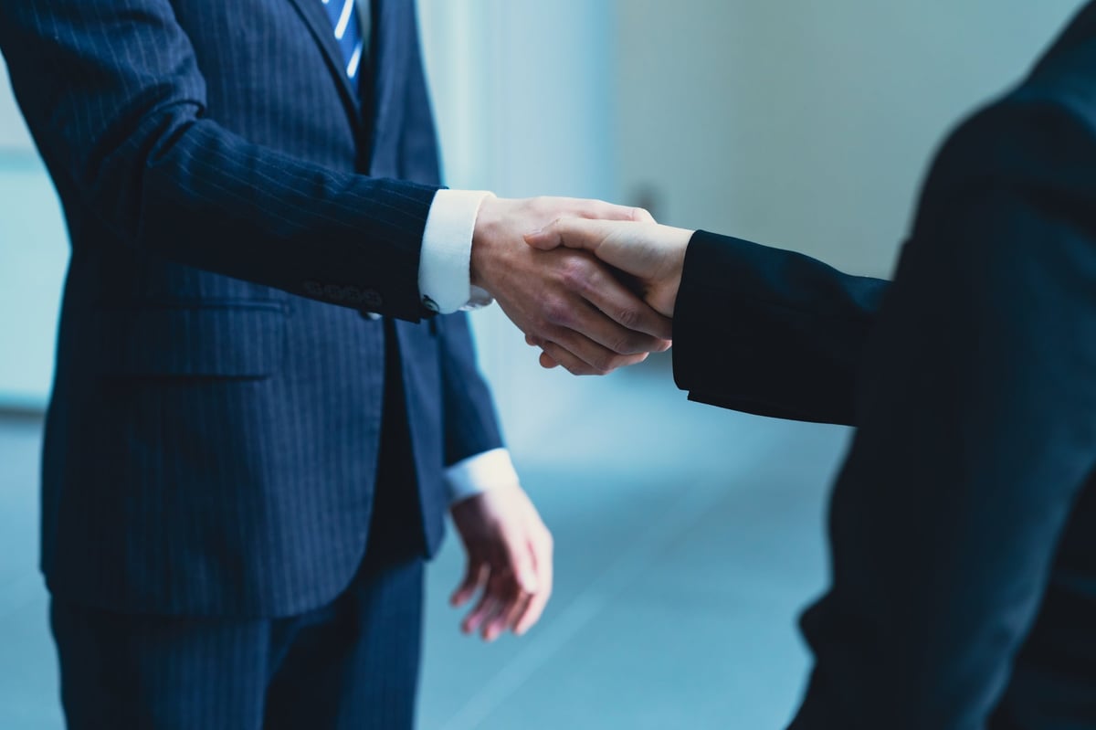 Business partnership handshake agreement