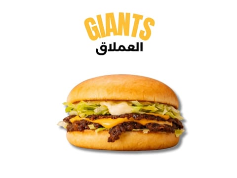 Giants burger with caramelized onions, melted cheese, and crispy bacon on a golden bun