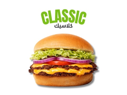Classic cheeseburger with lettuce, tomato, onion and melted cheese on a sesame bun