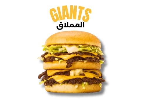 Giant triple-stacked burger with beef patties, cheese, and lettuce from Giants restaurant
